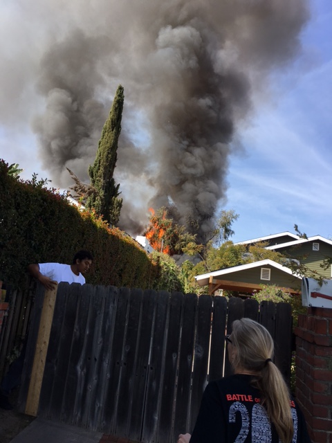 Fire and smoke seen over roof of house