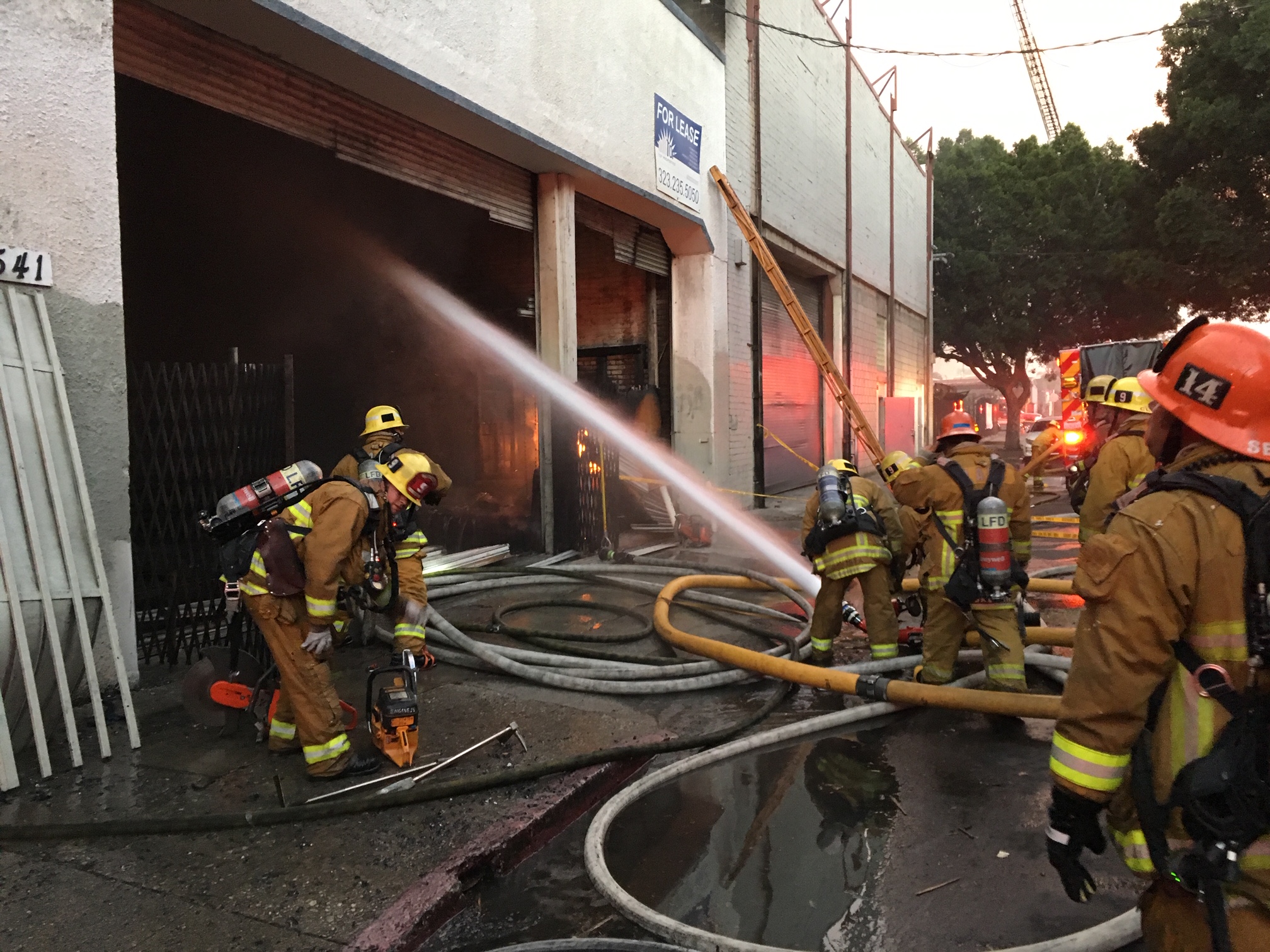 Fire trucks, engines and crews in front of building 