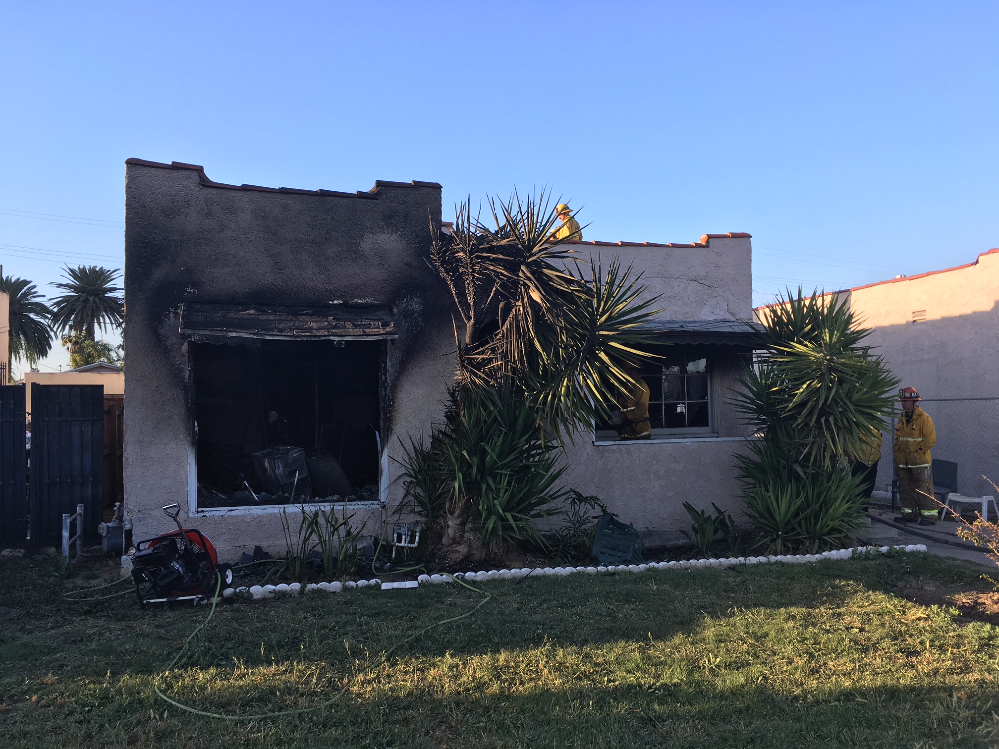 Front of small home with visible fire damage