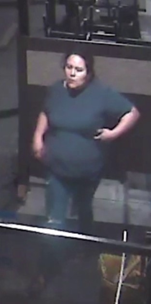 Screenshot of surveillance video showing female in blue shirt.