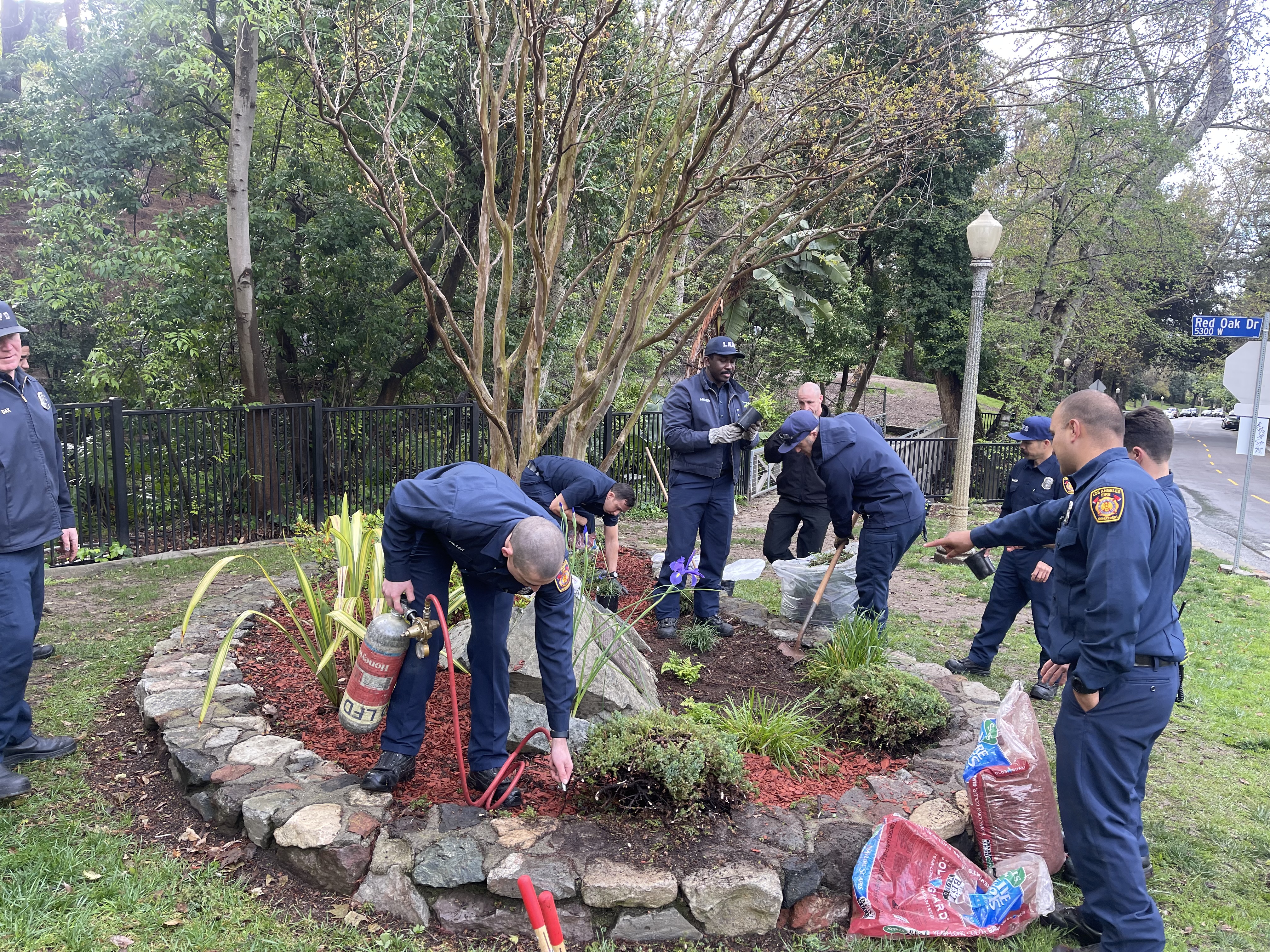 firefighters cleaning up the landscaping