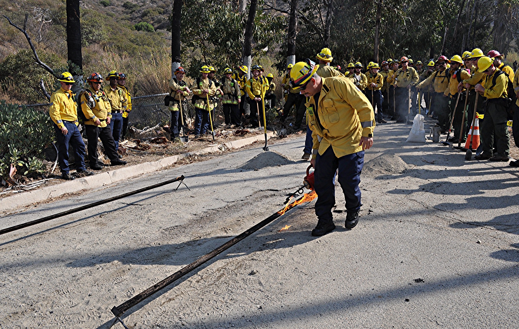 Group of Firefighters from several agencies gathered around an instructor during training