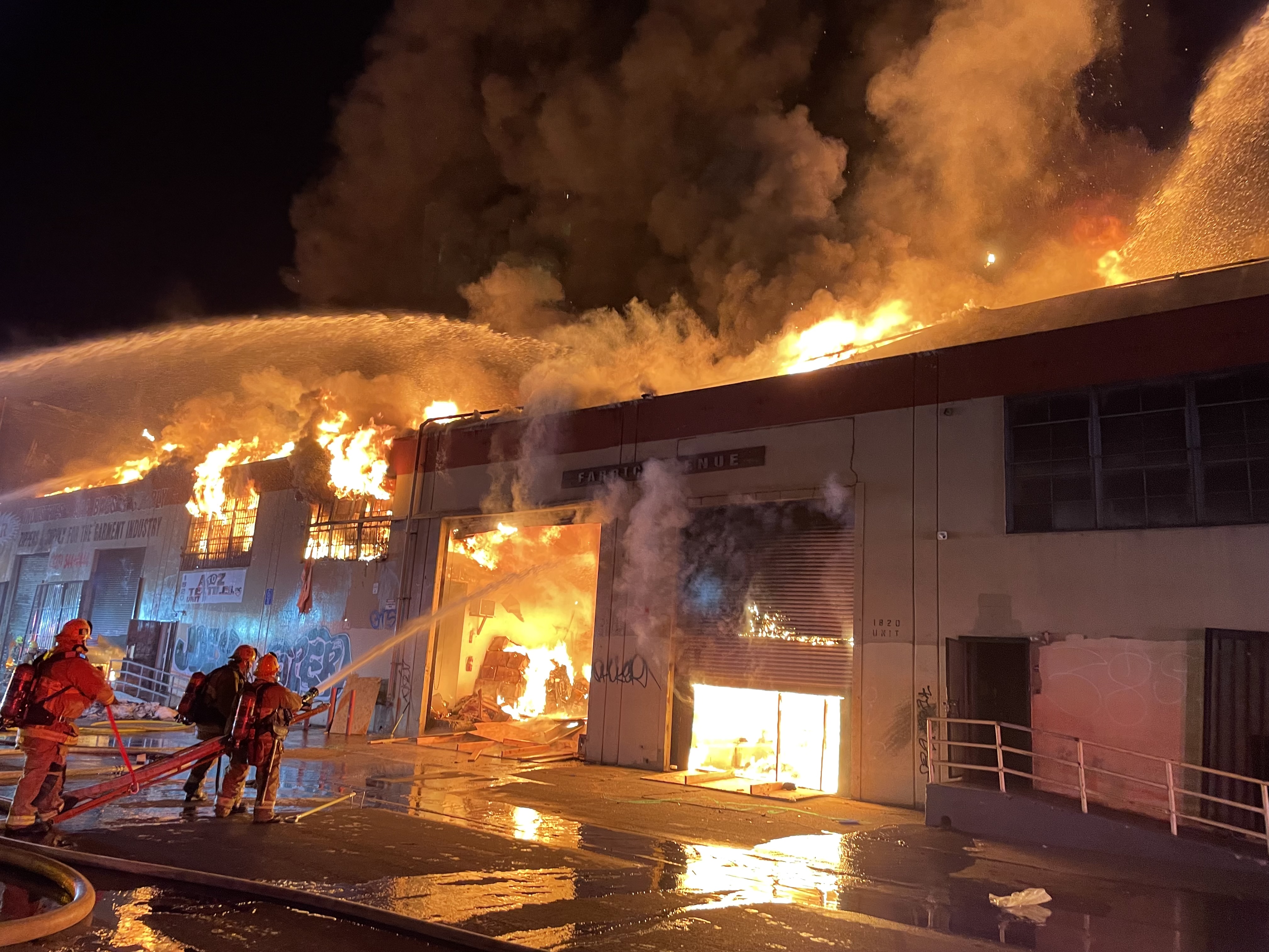 large blaze coming up from commercial building